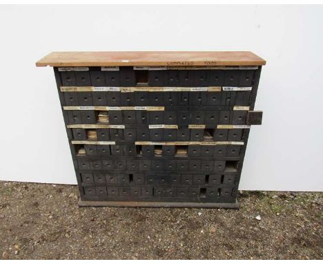 A railway station wooden ticket cabinet, named for various local stations containing various luggage labels