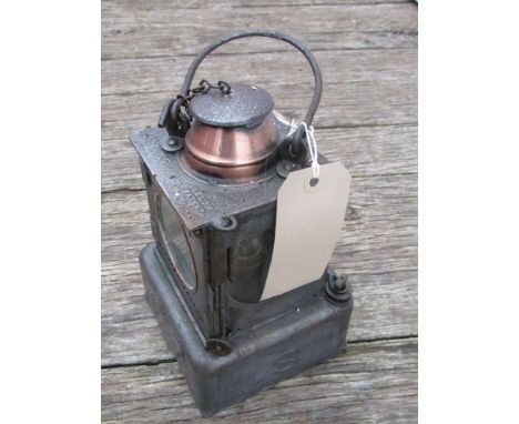 A railway signal lamp interior with reservoir and brass burner stamped "STOWMARKET" 