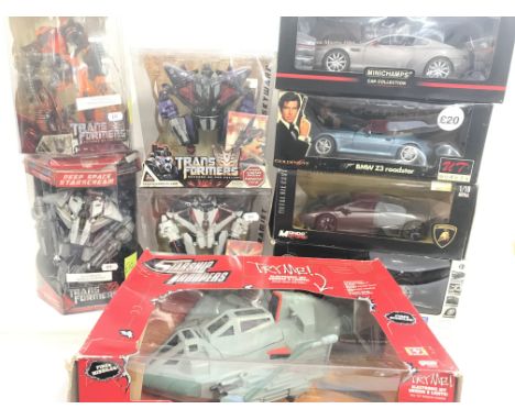 A Coof Boxed Toys including Star Ship Troopers. Transformers. And Diecast Cars including James Bond BMW Roadster. Boxes worn.