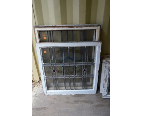 Four large leaded light window panels with stained glass decoration.