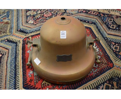 A large copper and brass spot light or lantern.
