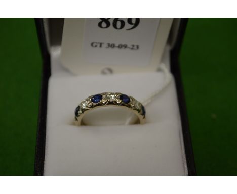 An 18ct white gold, diamond and sapphire seven stone ring, size N½.