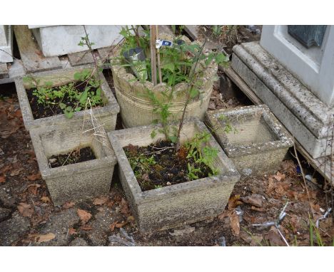 A reconstituted stone planter and four smaller square planters.