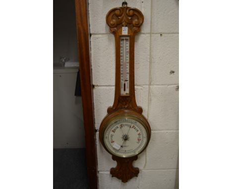 An oak barometer/thermometer.