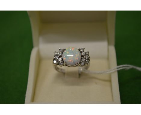 A decorative silver and opal ring, size M½.