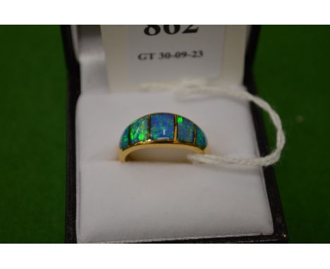 An 18ct gold and opal five stone ring, size M.