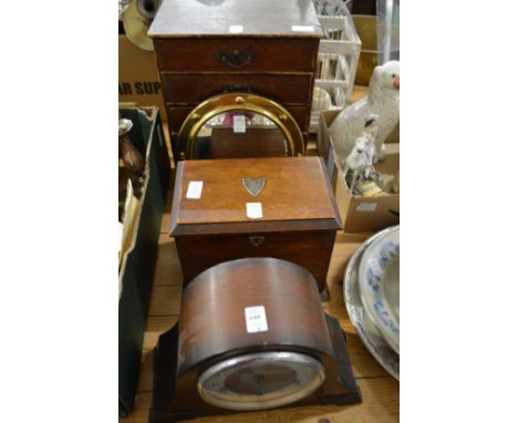 A mantle clock, table top cabinets, small mirror and a table top chest of drawers.