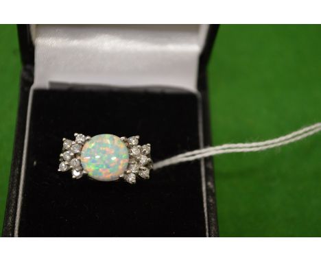 A decorative silver and opal ring, size M½.