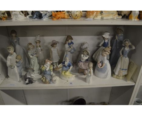 A group of Lladro, Nao and similar figures.