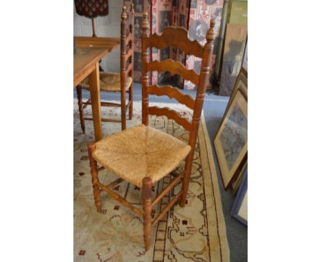 A set of six pine and rush seated ladder back dining chairs.