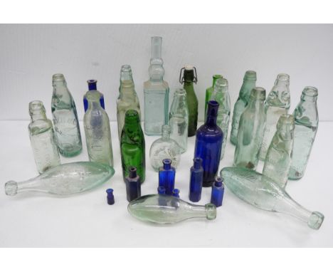 A collection of glass bottles, including an emerald green W. Fletcher, Ilkeston Codd marble bottle with embossed logo. Togeth