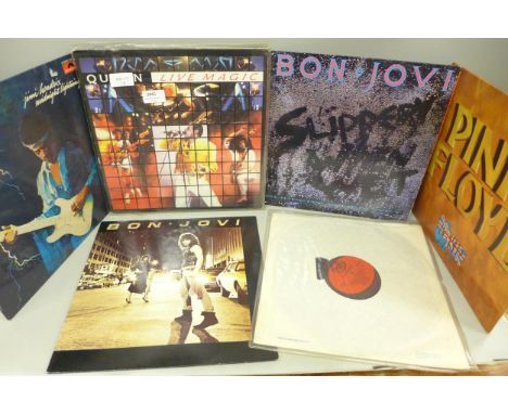 Sixteen vinyl LP records mostly rock artists including Queen, Bon Jovi, U2, Pink Floyd, Jimi Hendrix, and Meat Loaf.