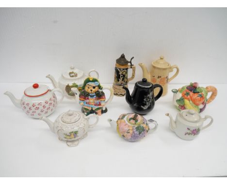 Ten porcelain teapots, including a novelty Teddy bear teapot and a German stoneware stein **PLEASE NOTE THIS LOT IS NOT ELIGI