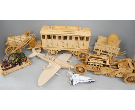 A collection of wooden model vehicles including train carriage and airplane 