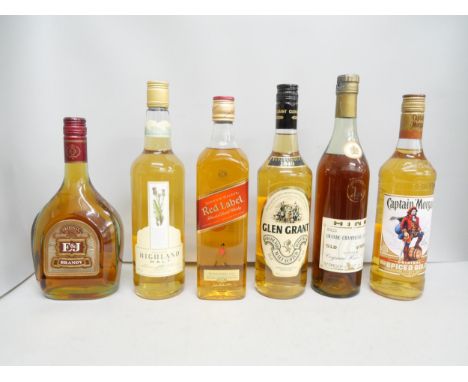 Three bottles of whisky, a bottle of Captain Morgan rum and two others   **PLEASE NOTE THIS LOT IS NOT AVAILABLE FOR PACKING 