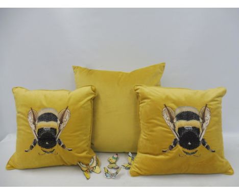 Three velvet cushions and four Portuguese handpainted ceramic butterflies. 