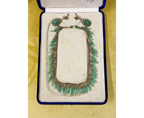 A cased Japanese jade necklace and earrings set.