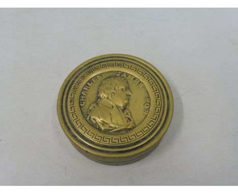 A 19th Century brass circular snuff box bearing the side profile of Charles James Fox to the lid. 