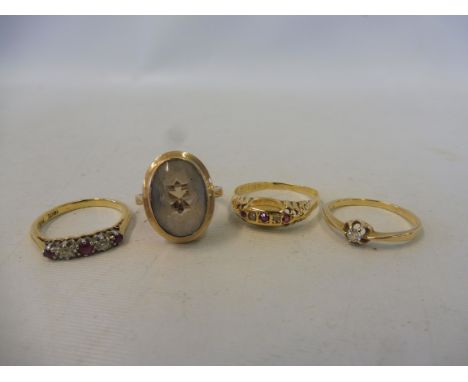 An 18ct gold and platinum ruby and diamond ring, size M, a second 18ct gold ring set with small rubies, size Q and two furthe