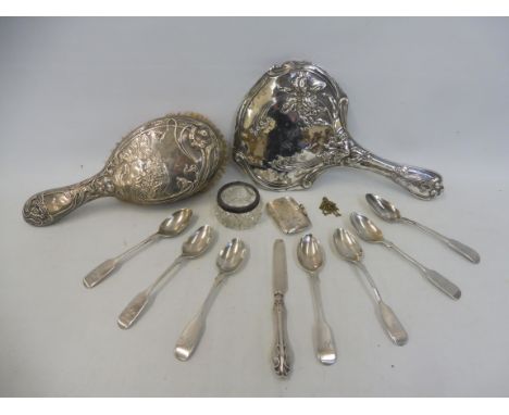 An Art Nouveau silver backed dressing table mirror, a similar silver backed brush, a silver vesta case, a silver butter knife