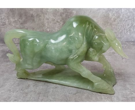 A carved jade charging bull 