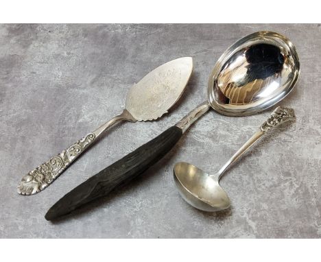 A large Burmese white metal serving spoon with carved ebony handle; A 20th century 800. grade silver ladle and cake server (3