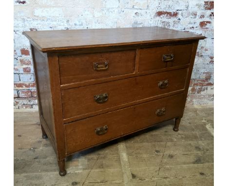 An early 20th century oak chest of two short above two long drawers, pressed Art Nouveau escutcheons, raised on tapering legs