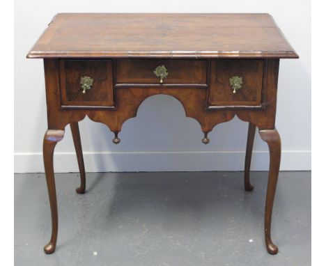 18TH CENTURY STYLE WALNUT LOWBOY or writing table, having cross banded, quarter veneered and feather banded top over an arran