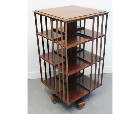 EDWARDIAN MAHOGANY SQUARE REVOLVING BOOKCASE with slatted sides on a star shaped base and ceramic casters.  87.5 x 46 x 46cm.