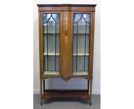 EDWARDIAN INLAID MAHOGANY TWO DOOR CHINA DISPLAY CABINET with satinwood foliate decoration, indented under shelf on square ta