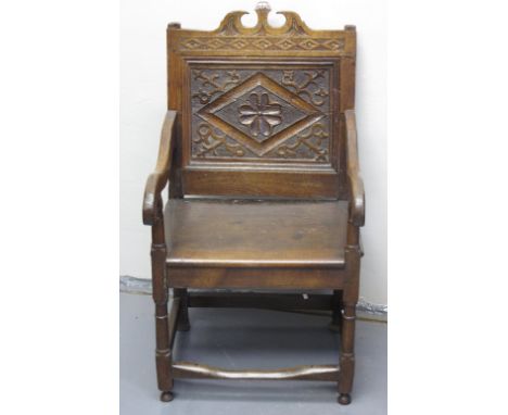 17TH CENTURY STYLE OAK WAINSCOT TYPE ELBOW CHAIR having broken arch cresting and lozenge moulded and carved panelled back wit