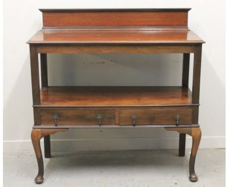 EARLY 20TH CENTURY MAHOGANY TWO TIER DUMB WAITER, having solid raised back over moulded top, under shelf with two frieze draw