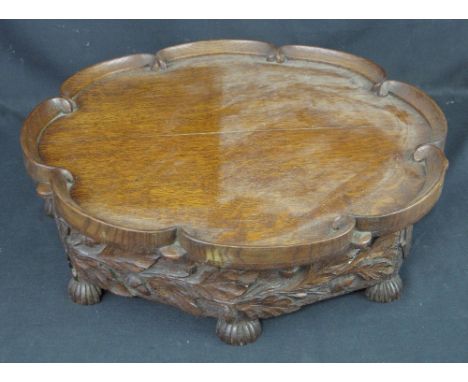 19TH CENTURY WELSH, CARVED OAK, LAZY SUSAN revolving table centre tray, having 'C' scroll moulded edge, the base overall carv