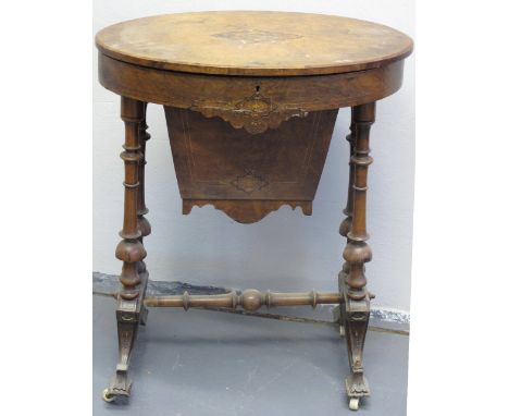 VICTORIAN INLAID WALNUT OVAL WORK TABLE, the hinge top revealing fitted interior with well on baluster turned tapering end su