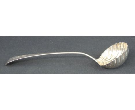LARGE SILVER SHELL DESIGN LADLE with long curved, tapering handle, engraved with armorial device, hand and dagger.  Rubbed ha