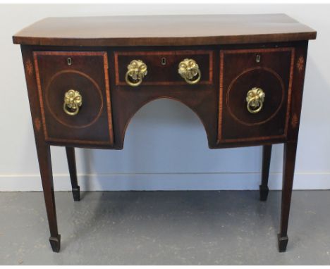 EARLY 19TH CENTURY MAHOGANY BOW FRONTED SIDEBOARD of small proportions, having a cross banded top over two deep drawers, one 