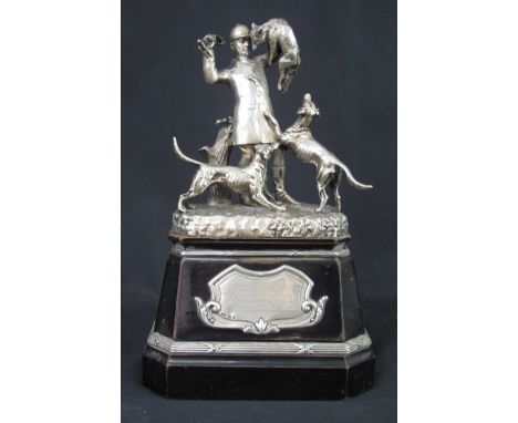 VICTORIAN SOLID SILVER PRESENTATION HUNTING TROPHY depicting huntsman with fox in hand and hounds at his feet on naturalistic