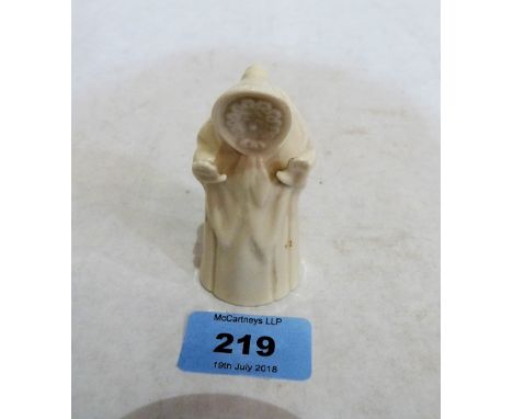 A Royal Worcester candle snuffer, Welsh lady, in white glaze. Unmarked