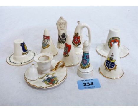 Seven various crested candle snuffers, a crested chamber stick and a 1911 coronation snuffer, boy yawning