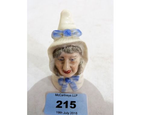A Royal Worcester candle snuffer, Mrs Caudle with blue bows. 1903