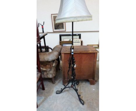 A wrought iron and brass lamp standard