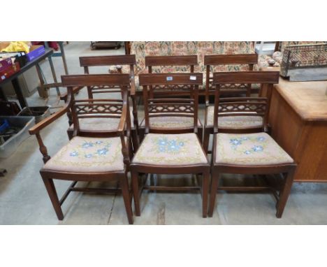 A set of six Regency style mahogany dining chairs, the backs with fret carved lattice rails over drop-in tapestry seats, the 