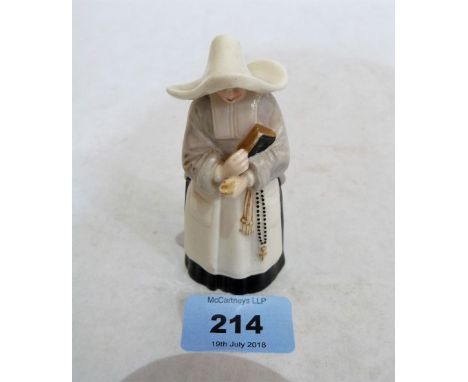 A Royal Worcester candle snuffer, nun with bible and rosary. 1892