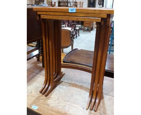 A nest of three light oak and veneered occasional tables