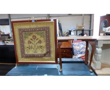 A firescreen with textile banner and an oak occasional table