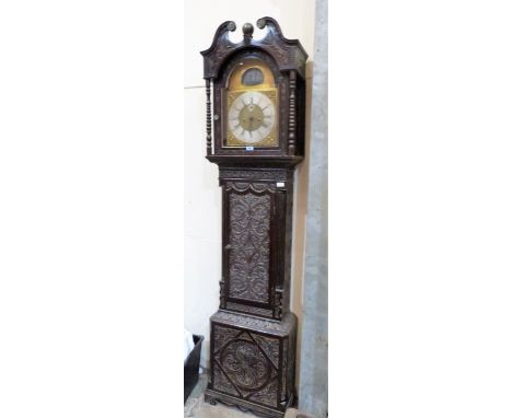 A 19th century oak cased longcase clock, the case later carved, the breakarch dial with silvered chapter and ship automaton s