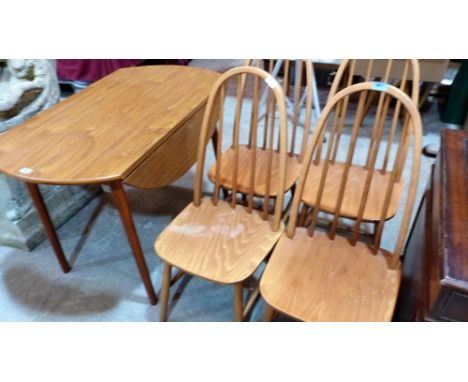 A set of Ercol style light wood stickback chairs and a similar drop-leaf table