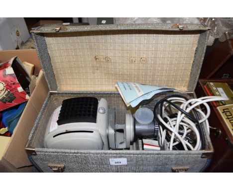 A Norris projector, boxed with assorted accessories