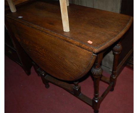 An early 20th century moulded oak drop flap gate leg occasional table