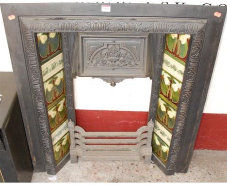 A circa 1900 cast iron and tile inset fire surround